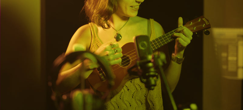 woman recording ukulele music