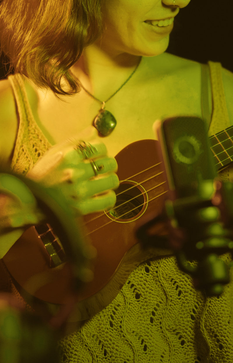 woman recording ukulele music